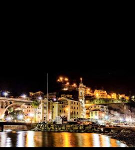 a view of a city at night with lights at A due passi dal mare in Sori