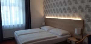 Postel nebo postele na pokoji v ubytování Hotel Flora