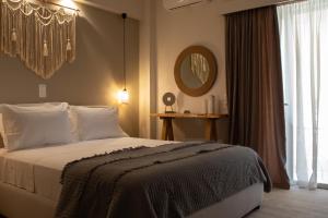 a bedroom with a bed and a large window at Langhi Apartments 2 in Mesolongion