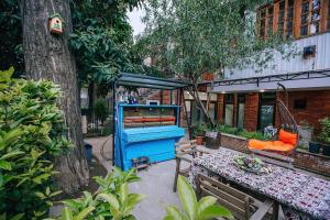 a swing in a yard next to a tree at Layla's Apartment in Tbilisi City