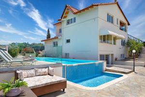 a villa with a swimming pool and a house at Villa Elihrisos in Chorafakia