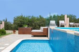 The swimming pool at or close to Villa Elihrisos