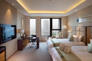 TV a/nebo společenská místnost v ubytování Kunshan Jinling Hotel