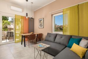 a living room with a couch and a table at Apartmani Heni in Vrbnik