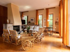 - un salon avec un canapé, une table et des chaises dans l'établissement Villa Cipressi by Victoria Palace, à Pesaro