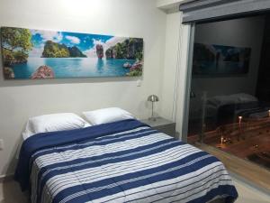 Ein Bett oder Betten in einem Zimmer der Unterkunft Departamento de lujo en el Malecón