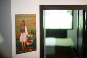 a picture of a girl with a basket of flowers at Good Hotel Yerevan in Yerevan