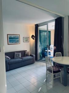 a living room with a couch and a table at Punta Ala Flat in Punta Ala