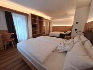 Postel nebo postele na pokoji v ubytování Hotel Piedibosco
