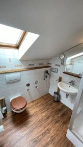 ein Bad mit einem WC und einem Waschbecken in der Unterkunft RamsAu-das Gasthaus in Bad Heilbrunn