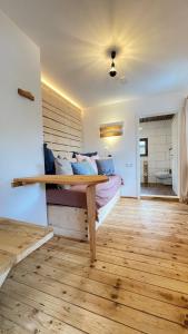 een slaapkamer met een bed met een houten muur bij RamsAu-das Gasthaus in Bad Heilbrunn