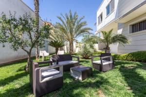 a patio with chairs and a table in a yard at Domus Japigia in Ugento