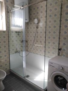 La salle de bains est pourvue d'une douche et d'un lave-linge. dans l'établissement Apartment Pineta 1817, à Fažana