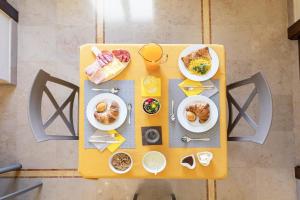 an overhead view of a yellow table with food on it at B&B Domus Japigia in Ugento