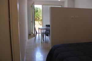 a room with a bed and a dining room with a table at Zibibbo Beach Apartments - Trapani in Trapani