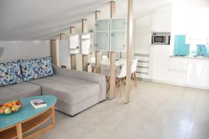salon z kanapą i stołem w obiekcie Beachfront Apartments - Villa Vita w mieście Stara Novalja