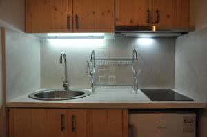 a kitchen with a sink and a counter top at STARA KOVAČNICA in Golubac +20 photos