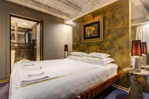 a bedroom with a large bed with white pillows at Boutique Hotel Hippocampus in Kotor