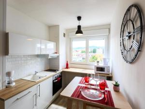 a kitchen with a table with two wine glasses on it at 1er Mai in Clermont-Ferrand