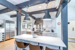 a kitchen with a large white island with chairs at Deer Park - Ski Ranches in Telluride
