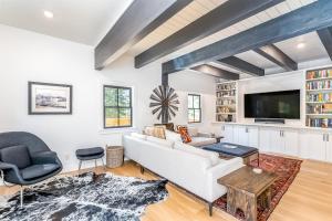 a living room with a white couch and a tv at Deer Park - Ski Ranches in Telluride