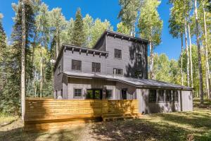 a house in the woods with a wooden fence at Deer Park - Ski Ranches in Telluride
