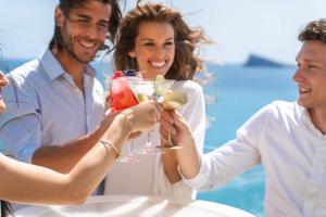 a group of people holding up wine glasses at Hotel Boutique Villa Venecia in Benidorm