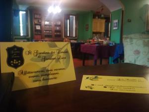 a sign sitting on top of a table next to a dining room at Il Giardino Dei Limoni in Montecassiano