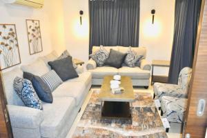 a living room with couches and a coffee table at Amwaj Resort For Families Only in Al Khobar