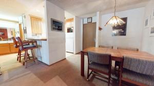 a kitchen and dining room with a wooden table and chairs at Summit Condominium #267 Condo in Mammoth Lakes