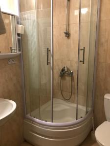 a shower with a glass door in a bathroom at Zajazd Dajana in Ustka