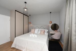 Giường trong phòng chung tại Malako Family Apartments