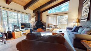 a living room with a couch and a fireplace at Chateau De Montagne #23 Condo in Mammoth Lakes