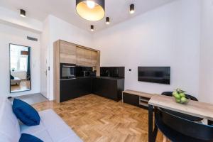 a living room with a couch and a table at Studio Matejki B in Bielsko-Biala