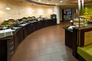 a buffet line in a restaurant with food at Holiday Inn Vicksburg by IHG in Vicksburg