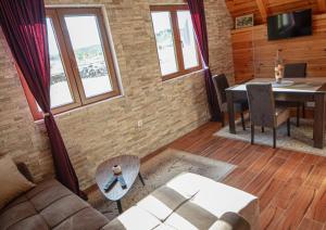 a living room with a couch and a table at Family house Eagle Eye in Žabljak