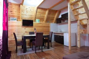 a kitchen and dining room with a table and chairs at Family house Eagle Eye in Žabljak +31 photos
