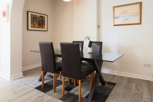 a dining room with a black table and chairs at Large 1 bed Apt, in the best location in Dublin! in Dublin