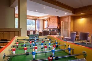 a group of toy figurines on a pool table at Le Rookie Mountain in Le Grand-Bornand