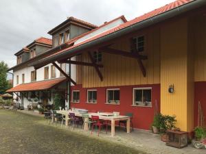 a building with tables and chairs outside of it at Moorwiesenhof in Ostrach