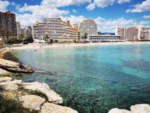 a beach in front of a city with tall buildings at Superior Calpe Pearl Beach in Calpe