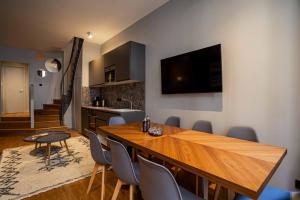 a dining room with a wooden table and chairs at 136 - Urban Beaumarchais Voltaire in Paris