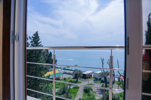 a view of the ocean from a window at Hotel BELLA in Gagra