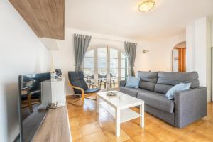 a living room with a couch and a table at White Sands 306 in Arenal d'en Castell