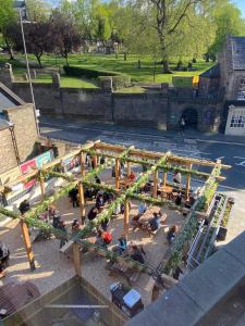 an aerial view of a park with people sitting on the ground at Kick Ass Greyfriars (18+) in Edinburgh