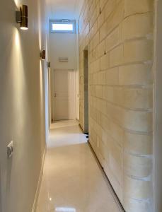 a hallway with a brick wall and a skylight at HABITARE Lecce & Salento in Lecce