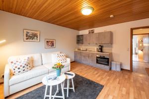a living room with a white couch and a table at Landhaus Jägerhof in Börnsdorf