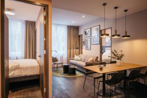 a hotel room with a bed and a dining room at YAYS The Hague Willemspark in The Hague