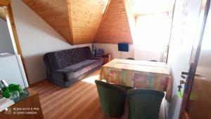 a living room with a couch and a table at Pokoje Jadwiga Konkel in Jastarnia