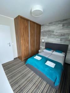 Posteľ alebo postele v izbe v ubytovaní Apartamenty Krynica No.1